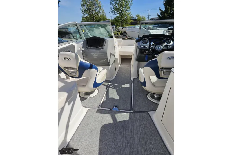 Slide: The Image of 2016 Chaparral 244 Sunesta boat interior with blue and white seating and modern dashboard. - 60