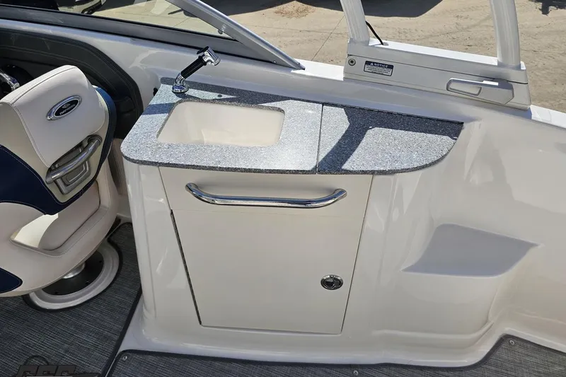 Slide: The Image of Interior of 2016 Chaparral 244 Sunesta boat featuring a sink and seating area. - 61