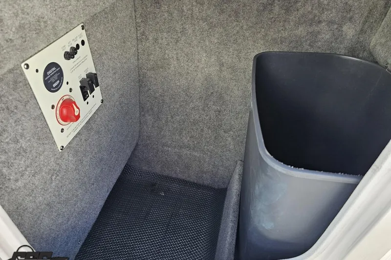 Slide: The Image of 2016 Chaparral 244 Sunesta interior storage with control panel and trash bin. - 62
