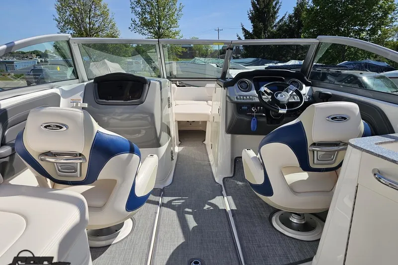 Slide: The Image of 2016 Chaparral 244 Sunesta boat interior with modern dashboard and comfortable seating. - 63