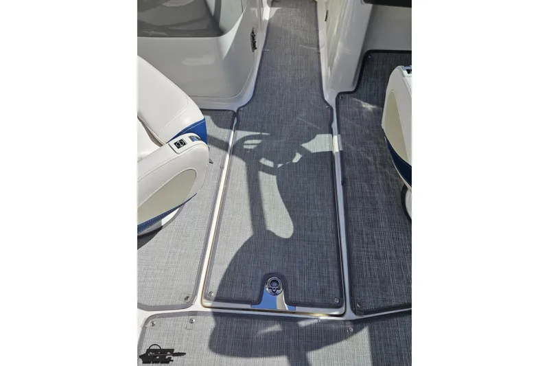 Slide: The Image of 2016 Chaparral 244 Sunesta boat interior with gray flooring and white seating. - 64