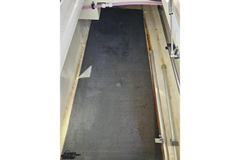 Slide: The Image of Storage compartment of a 2016 Chaparral 244 Sunesta boat, featuring a textured floor. - 65