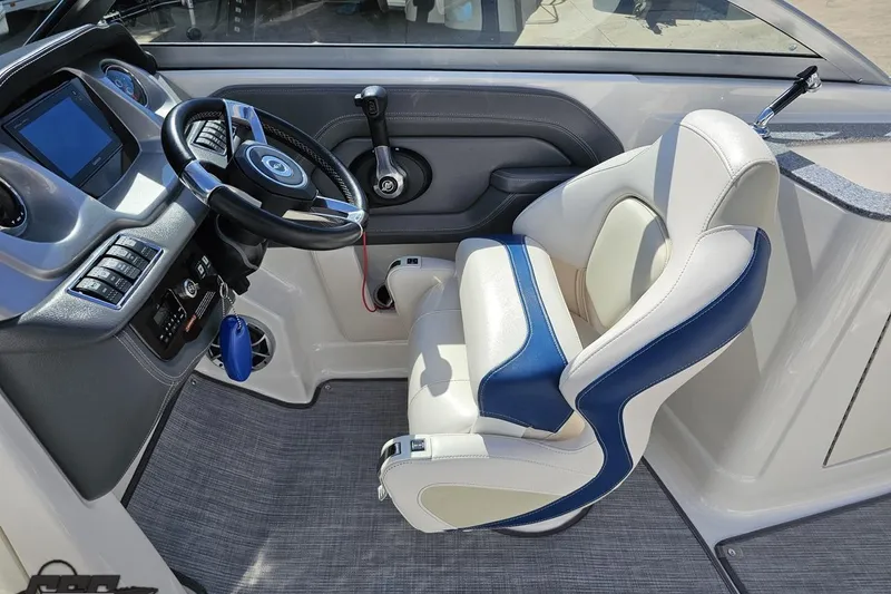 Slide: The Image of 2016 Chaparral 244 Sunesta boat cockpit with steering wheel and captain's chair. - 66