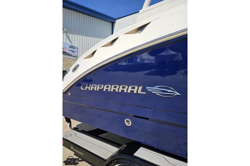 Slide: The Image of 2016 Chaparral 244 Sunesta boat side view with logo, blue and white design. - 7