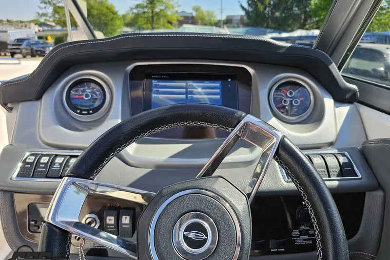 Slide: The Image of Steering wheel and dashboard of 2016 Chaparral 244 Sunesta boat. - 71