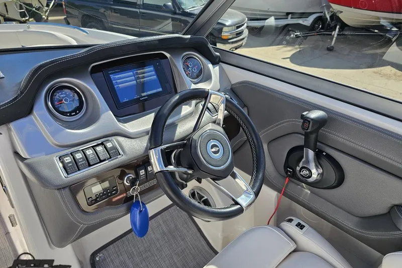 Slide: The Image of 2016 Chaparral 244 Sunesta boat dashboard with steering wheel and control panel. - 72