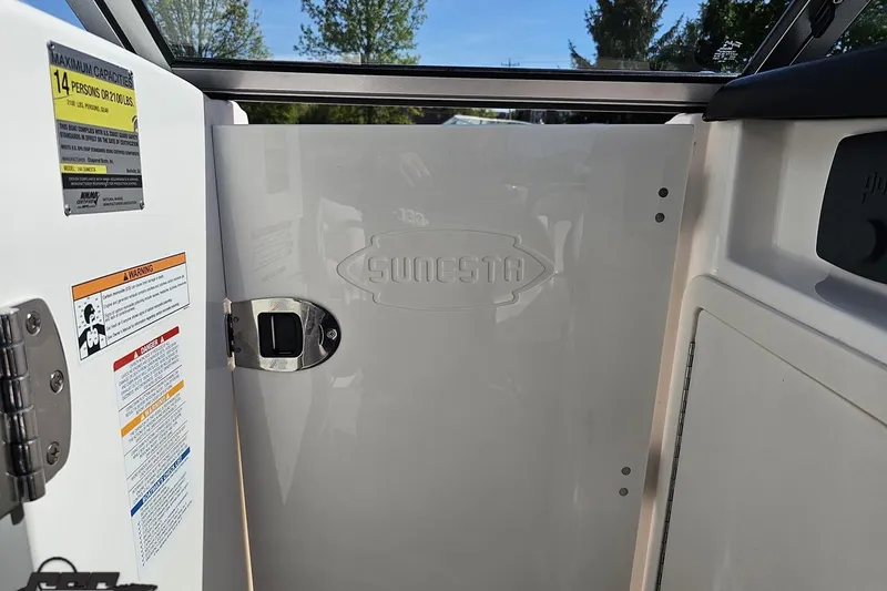 Slide: The Image of Interior view of 2016 Chaparral 244 Sunesta boat with capacity and safety labels. - 82