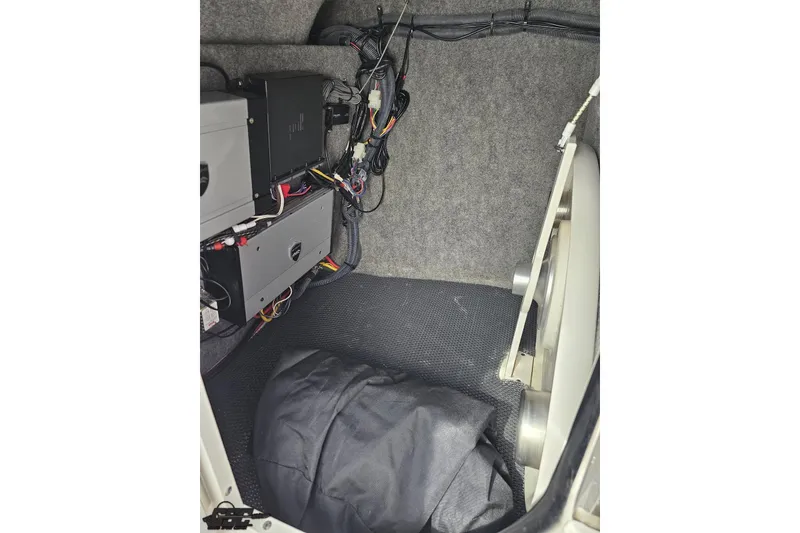 Slide: The Image of Interior view of 2016 Chaparral 244 Sunesta boat showing wiring and storage area. - 85