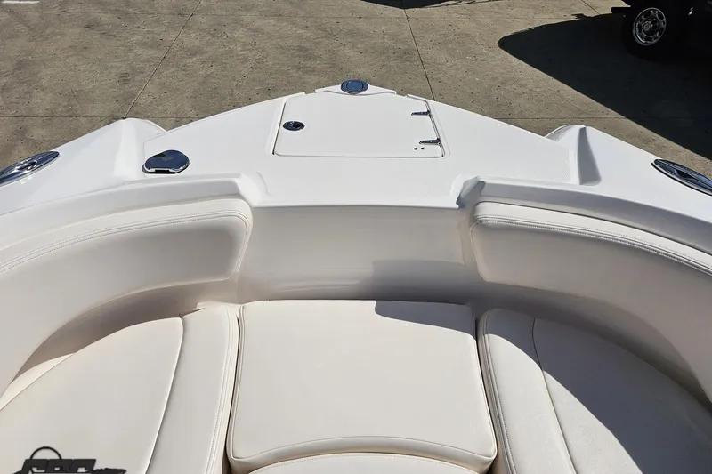Slide: The Image of 2016 Chaparral 244 Sunesta boat interior with white seating and storage compartment. - 88