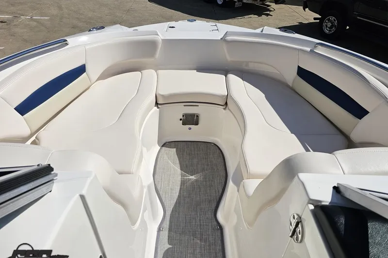 Slide: The Image of 2016 Chaparral 244 Sunesta boat interior with white seating and blue accents. - 90