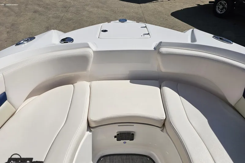 Slide: The Image of 2016 Chaparral 244 Sunesta boat interior with white cushioned seating. - 91
