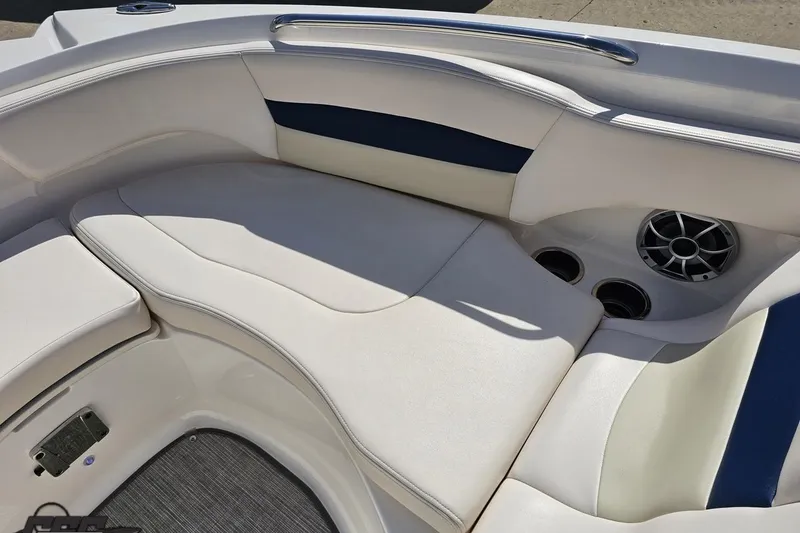 Slide: The Image of 2016 Chaparral 244 Sunesta boat interior with white seating and built-in speakers. - 92