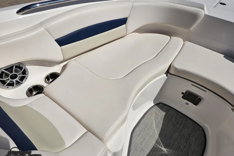 Slide: The Image of 2016 Chaparral 244 Sunesta boat interior with cushioned seating and cup holders. - 93