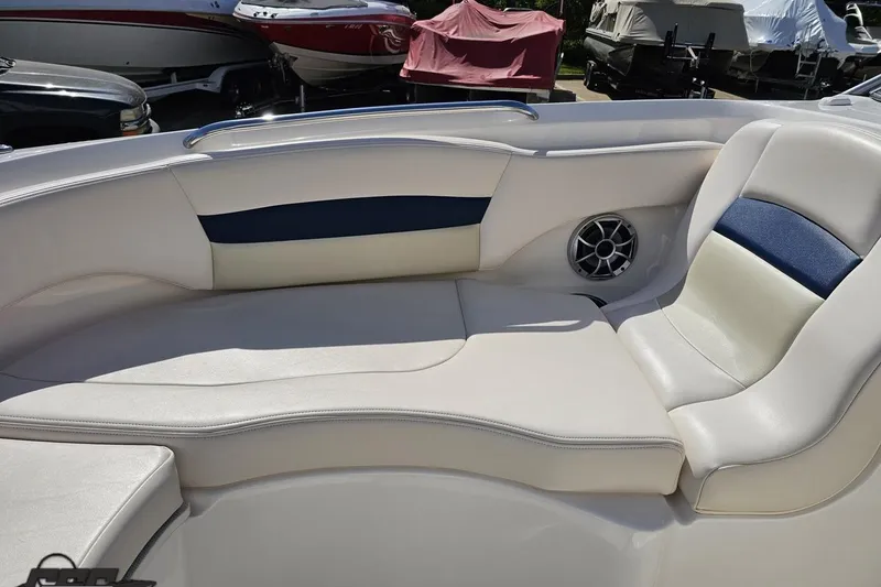 Slide: The Image of 2016 Chaparral 244 Sunesta boat interior with white and blue seating, speaker detail. - 95