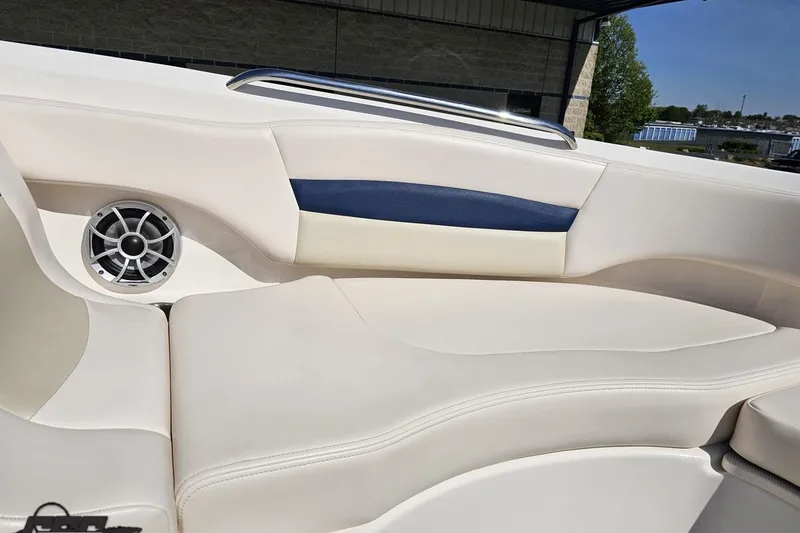 Slide: The Image of 2016 Chaparral 244 Sunesta boat interior with white seating and speaker detail. - 96