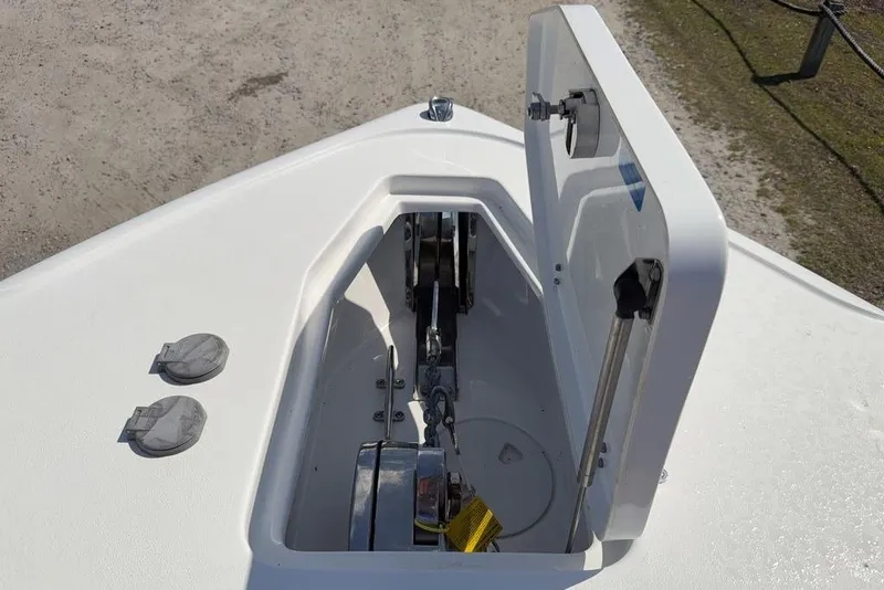 Slide: The Image of 2024 Sea Hunt Ultra 265 SE anchor locker with open hatch on deck. - 12