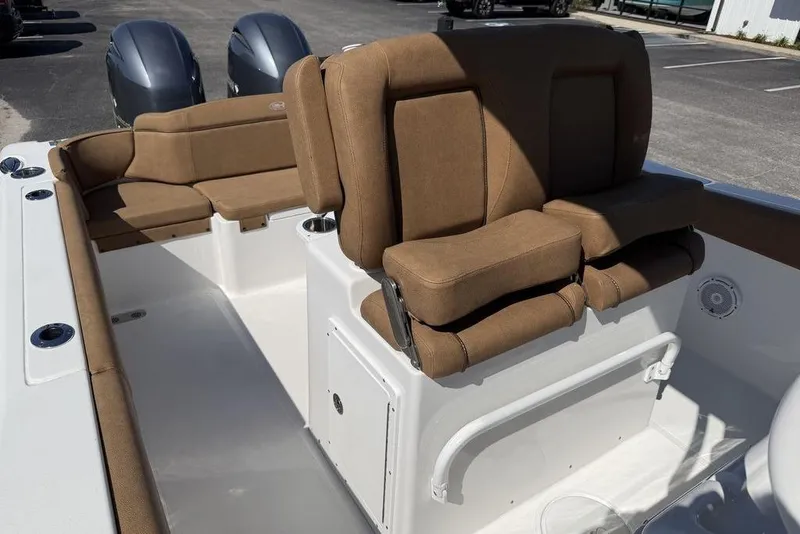 Slide: The Image of 2024 Sea Hunt Ultra 265 SE boat interior with brown cushioned seating. - 14