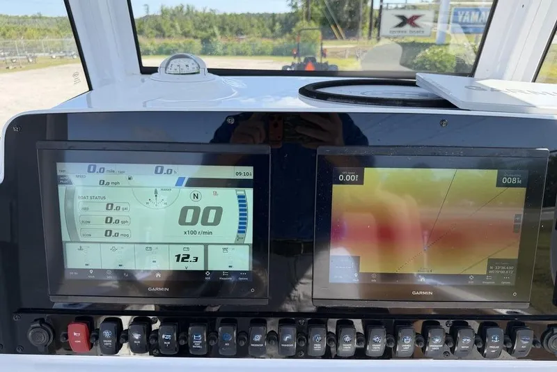 Slide: The Image of Dashboard of 2024 Sea Hunt Ultra 265 SE with Garmin navigation displays. - 15
