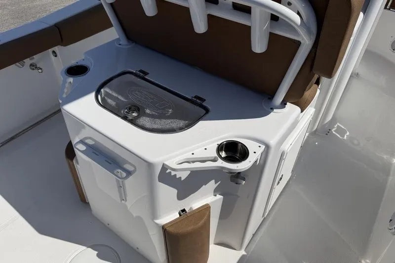 Slide: The Image of 2024 Sea Hunt Ultra 265 SE boat interior with seating and cup holders. - 16