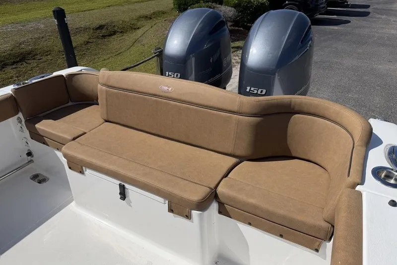 Slide: The Image of 2024 Sea Hunt Ultra 265 SE boat with tan seating and dual 150 horsepower engines. - 17