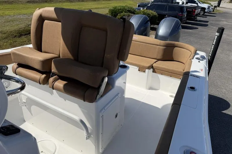 Slide: The Image of 2024 Sea Hunt Ultra 265 SE boat interior with tan seating and dual engines. - 22