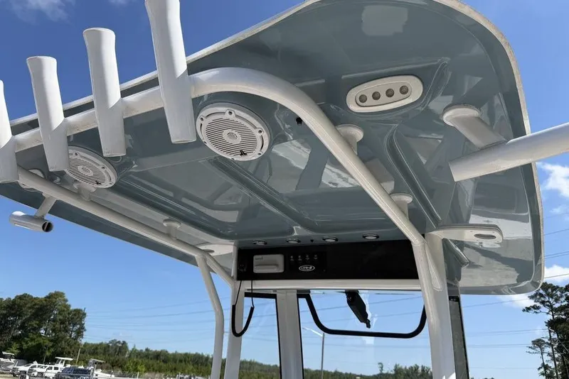 Slide: The Image of 2024 Sea Hunt Ultra 265 SE boat's T-top with rod holders and speakers. - 25