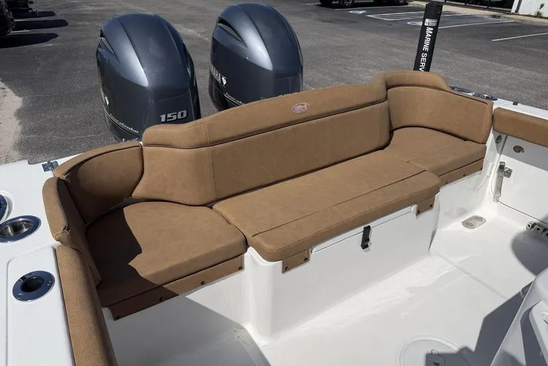 Slide: The Image of 2024 Sea Hunt Ultra 265 SE boat with tan seating and dual Yamaha 150 engines. - 6