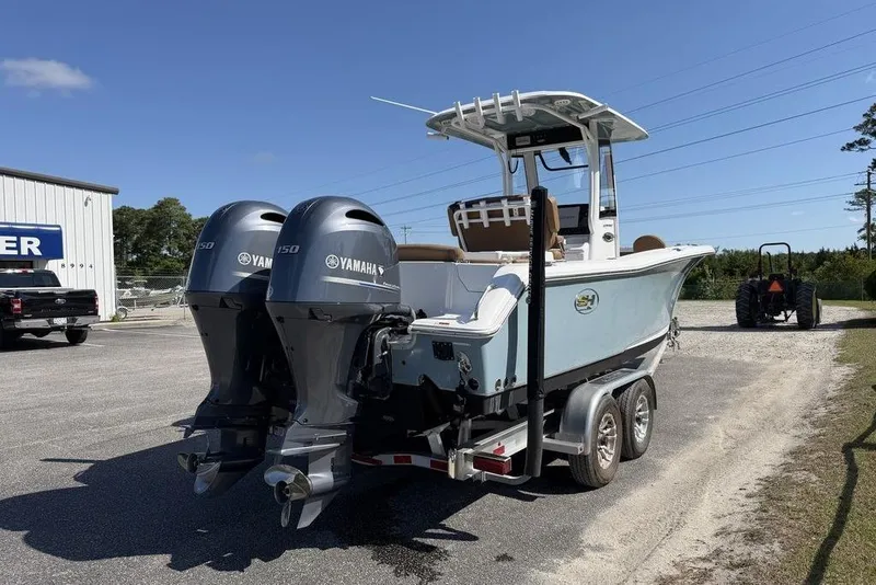 Slide: The Image of 2024 Sea Hunt Ultra 265 SE boat with dual Yamaha engines on a trailer. - 7