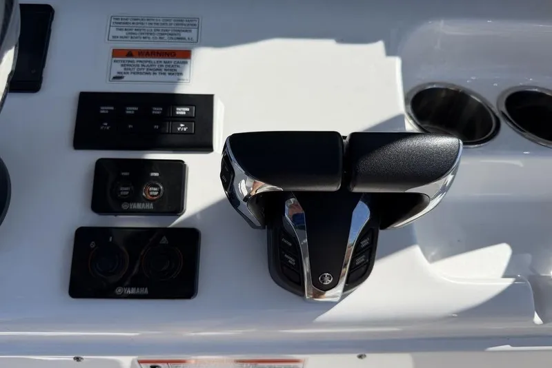 Slide: The Image of 2024 Sea Hunt Ultra 265 SE boat controls with Yamaha throttle and switches. - 8