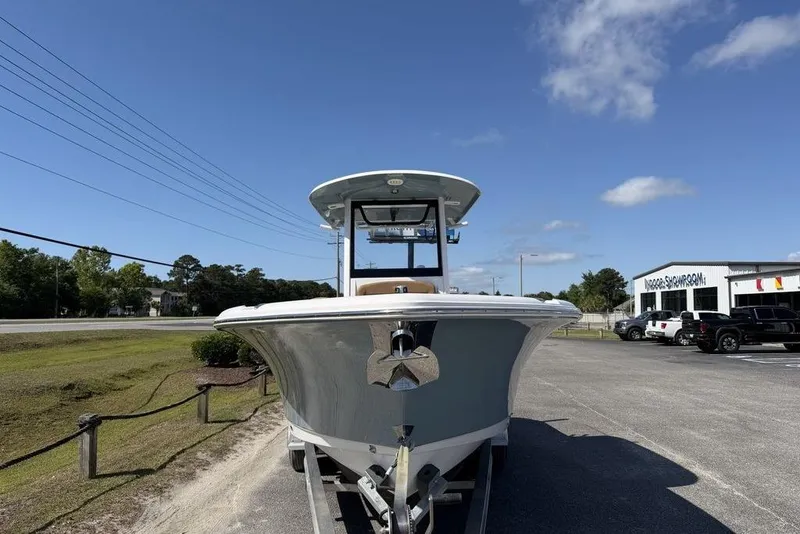Slide: The Image of 2024 Sea Hunt Ultra 265 SE boat on trailer, parked near dealership under clear sky. - 9