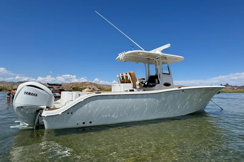Slide: The Image of 2024 NauticStar 292 Legacy boat with Yamaha engine in clear water. - 19