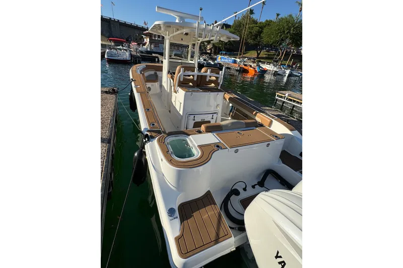 Slide: The Image of 2024 NauticStar 292 Legacy boat docked, featuring spacious deck and modern design. - 21