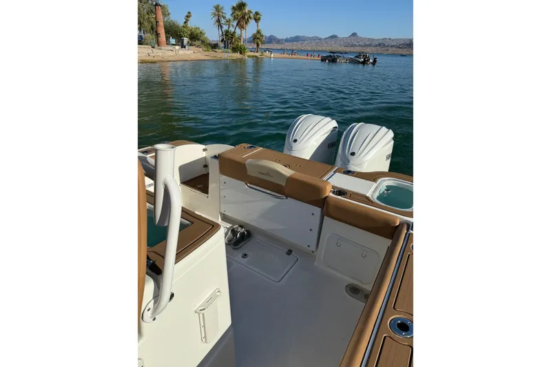 Slide: The Image of 2024 NauticStar 292 Legacy boat with dual engines on a scenic lake. - 22