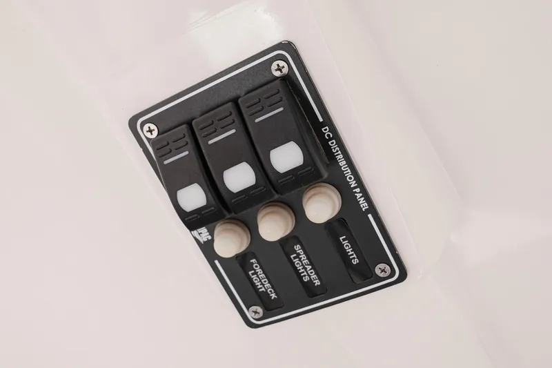 Slide: The Image of Control panel of 2024 NauticStar 292 Legacy boat with switches for lights and spreader lights. - 37