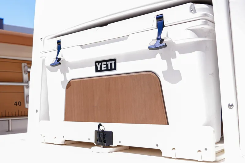 Slide: The Image of YETI cooler on 2024 NauticStar 292 Legacy boat, secured with blue latches. - 7