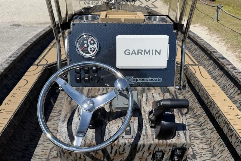 Slide: The Image of Steering console of 2026 Xpress H22B Bay boat with Garmin navigation system. - 1