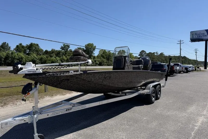 Slide: The Image of 2026 Xpress H22B Bay boat on trailer in parking lot, sunny day. - 10