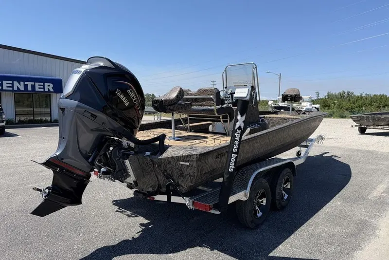 Slide: The Image of 2026 Xpress H22B Bay boat with Yamaha engine on trailer, parked outdoors. - 6