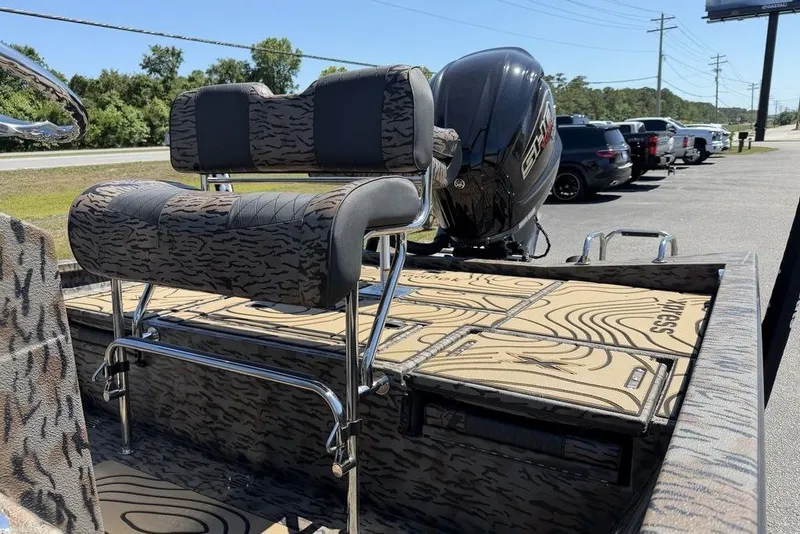 Slide: The Image of 2026 Xpress H22B Bay boat with patterned seating and powerful outboard motor. - 7