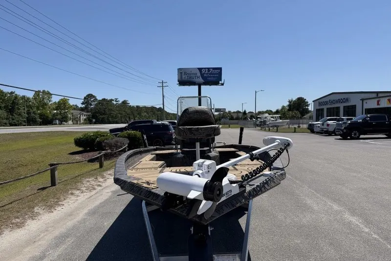 Slide: The Image of 2026 Xpress H22B Bay boat on display outside a showroom under clear blue skies. - 8