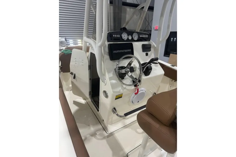 Slide: The Image of 2023 Pioneer 202 Islander boat console with steering wheel and navigation controls. - 4