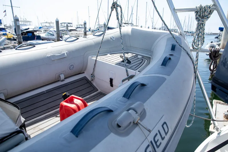 Slide: The Image of Inflatable boat docked at marina, featuring a red fuel canister, Morgan Catalina 38, 1994 model. - 11