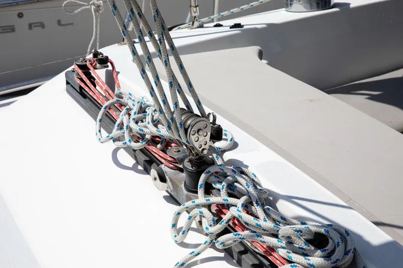 Slide: The Image of Deck rigging on a 1994 Morgan Catalina 38 sailboat, featuring ropes and pulleys. - 12