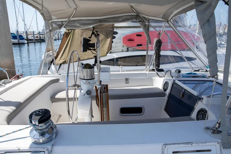 Slide: The Image of 1994 Morgan Catalina 38 sailboat cockpit with steering wheel, docked at marina. - 16
