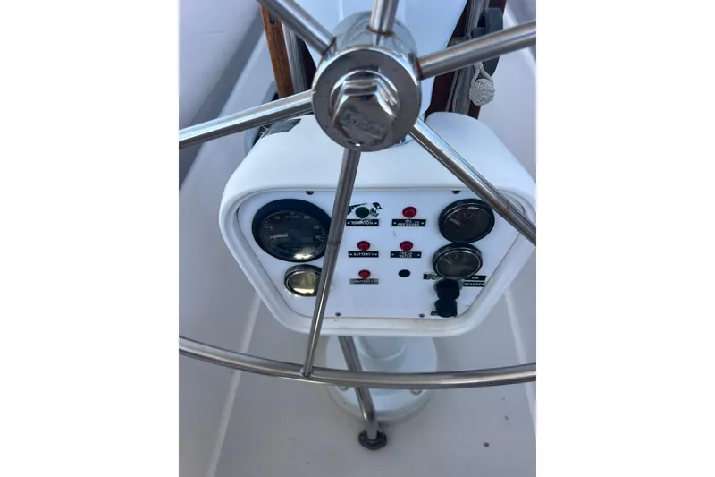 Slide: The Image of Interior of 1994 Morgan Catalina 38 sailboat with wooden furnishings and blue seating. - 22