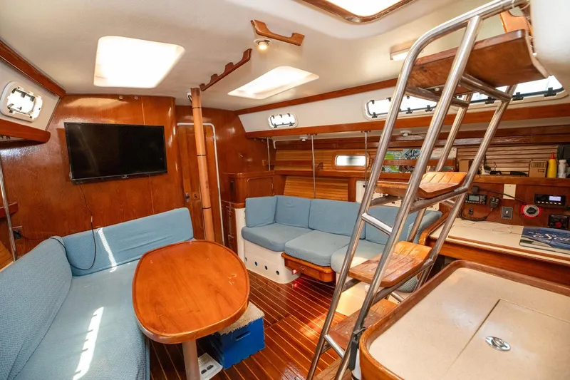 Slide: The Image of Interior of 1994 Morgan Catalina 38 sailboat with wooden flooring and cozy seating area. - 25