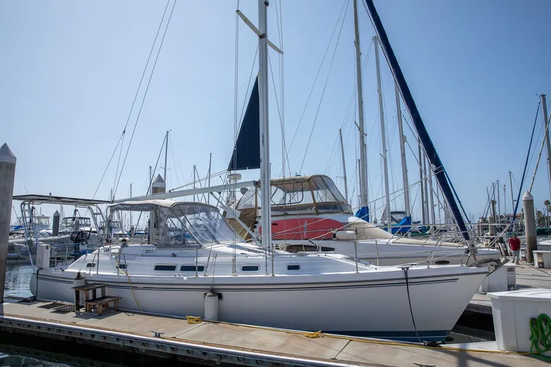 Slide: The Image of 1994 Morgan Catalina 38 sailboat docked at marina under clear blue sky. - 3
