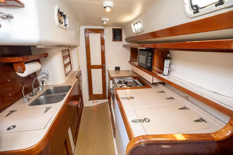 Slide: The Image of Interior of 1994 Morgan Catalina 38 yacht with wooden cabinetry and dual sink. - 30