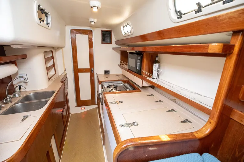 Slide: The Image of Cozy 1994 Morgan Catalina 38 yacht kitchen with wood cabinetry and modern appliances. - 31