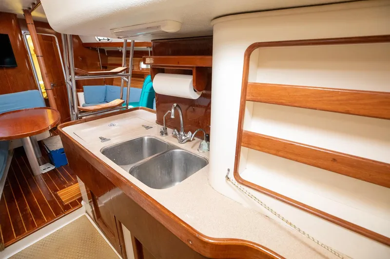 Slide: The Image of Navigation station on a 1994 Morgan Catalina 38 sailboat with communication equipment and a nautical book. - 33